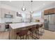 Modern kitchen with stainless steel appliances, pendant lights, and a large center island at 2104 4Th S St, St Petersburg, FL 33705