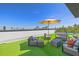 Inviting roof deck boasts turf, outdoor seating, and an umbrella, ideal for entertaining at 2104 4Th S St, St Petersburg, FL 33705