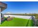 A spacious rooftop deck with artificial turf, patio furniture, and an umbrella with clear blue skies above at 2104 4Th S St, St Petersburg, FL 33705