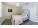 Well-lit bedroom featuring stylish bedframe, hardwood floors and neutral color scheme at 2114 S Venus St, Tampa, FL 33629