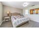 Comfortable bedroom with natural light has a ceiling fan, wood floors, and ensuite bathroom at 2114 S Venus St, Tampa, FL 33629