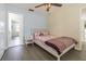 Comfortable bedroom featuring plush bedding, neutral walls and hardwood flooring at 2114 S Venus St, Tampa, FL 33629
