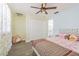 Cozy bedroom with floral accents, ample closet space and ceiling fan at 2114 S Venus St, Tampa, FL 33629