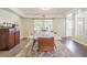 A spacious dining room featuring hardwood floors, a large marble table, and lots of natural light at 2114 S Venus St, Tampa, FL 33629
