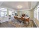 A spacious dining room featuring hardwood floors, a large marble table, and lots of natural light at 2114 S Venus St, Tampa, FL 33629
