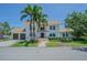 A two-story home with a white exterior, a brown roof and two palm trees in the front yard at 2114 S Venus St, Tampa, FL 33629