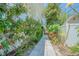 Exterior view of a home surrounded by lush landscaping with a paver walkway at 2114 S Venus St, Tampa, FL 33629