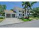 Angle view of a white two-story home with a driveway leading to a two-car garage at 2114 S Venus St, Tampa, FL 33629