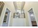 A two-story foyer with an open staircase featuring black iron railing at 2114 S Venus St, Tampa, FL 33629