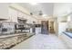 Bright kitchen featuring white cabinetry, stainless steel appliances, marble countertops and tile floors at 2114 S Venus St, Tampa, FL 33629