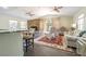 Open concept living space with seating area and a stone fireplace as focal point at 2114 S Venus St, Tampa, FL 33629