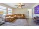 Open living room with a leather sofa, area rug, and abundant natural light at 2114 S Venus St, Tampa, FL 33629