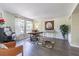 Inviting living room featuring hardwood floors, piano, and a bright window at 2114 S Venus St, Tampa, FL 33629