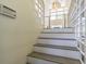 Staircase with modern railing, vaulted ceilings and large window that provides natural light at 2114 S Venus St, Tampa, FL 33629