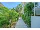 Landscaped walkway features lush greenery and leads to the home's entrance at 2114 S Venus St, Tampa, FL 33629