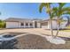 Beautiful single-story home featuring tropical landscaping, a spacious driveway, and an attached two-car garage at 2161 Aqui Esta Dr, Punta Gorda, FL 33950