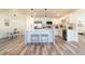 Bright kitchen with white cabinets, stainless steel appliances, a center island, and modern pendant lighting at 2161 Aqui Esta Dr, Punta Gorda, FL 33950