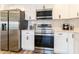 Updated kitchen featuring stainless steel appliances, white cabinetry, a range, and a microwave at 2161 Aqui Esta Dr, Punta Gorda, FL 33950