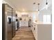 Modern kitchen with stainless steel appliances, white cabinets, a tile backsplash, and a center island at 2161 Aqui Esta Dr, Punta Gorda, FL 33950