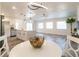 Open-concept living space featuring a modern kitchen island, stainless appliances, and a casual dining space at 2161 Aqui Esta Dr, Punta Gorda, FL 33950