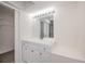 Bright bathroom vanity with white cabinets, chrome faucet, and Hollywood lighting at 2167 Corfell St, Port Charlotte, FL 33948