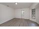 Bedroom featuring wood-look flooring, window view and ensuite bathroom at 2167 Corfell St, Port Charlotte, FL 33948
