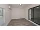 Bedroom with wood-look floors, natural light, mini-split and sliding glass door at 2167 Corfell St, Port Charlotte, FL 33948