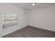 Bright bedroom with wood-look flooring, window view and mini-split at 2167 Corfell St, Port Charlotte, FL 33948