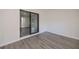 Cozy bedroom with wood-look floors and a sliding glass door leading to the bathroom at 2167 Corfell St, Port Charlotte, FL 33948