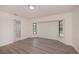Bright bedroom featuring wood-look floors, two windows, and an ensuite bathroom at 2167 Corfell St, Port Charlotte, FL 33948