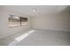 Bright, white bedroom with large window overlooking mature landscape and marble floors at 2167 Corfell St, Port Charlotte, FL 33948