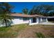Single-story home with a brown roof, white exterior, and attached garage at 2167 Corfell St, Port Charlotte, FL 33948