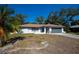Inviting single-story house with a gray garage door and a quaint front porch at 2167 Corfell St, Port Charlotte, FL 33948
