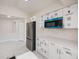 Bright kitchen with stainless steel refrigerator, blue microwave and white cabinets at 2167 Corfell St, Port Charlotte, FL 33948