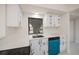 Compact kitchen featuring white cabinets, quartz countertops, and stainless steel appliances at 2167 Corfell St, Port Charlotte, FL 33948