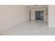 Open living room with sliding glass doors and access to kitchen with bar at 2167 Corfell St, Port Charlotte, FL 33948