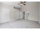 A spacious bedroom with plush carpeting and multiple doorways allowing access to other rooms at 2306 Lake Woodberry Cir, Brandon, FL 33511