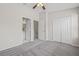 Large bedroom with plush carpeting and doorways to the bathroom and a closet at 2306 Lake Woodberry Cir, Brandon, FL 33511