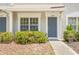 Charming townhouse featuring a blue door and desert landscaping at 2306 Lake Woodberry Cir, Brandon, FL 33511