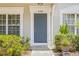 Inviting front entry of townhome featuring a blue door and desert landscaping at 2306 Lake Woodberry Cir, Brandon, FL 33511