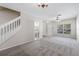 Inviting living room with carpet, adjacent half-bathroom, and a staircase at 2306 Lake Woodberry Cir, Brandon, FL 33511