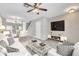 Tastefully decorated living room features carpet, white sofas, and a glass coffee table at 2306 Lake Woodberry Cir, Brandon, FL 33511