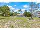 Community park with picnic benches, lush green lawn, and mature trees, perfect for outdoor activities at 2306 Lake Woodberry Cir, Brandon, FL 33511