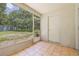 Enclosed patio with tiled floors and screened walls offering views of the fenced yard at 2306 Lake Woodberry Cir, Brandon, FL 33511