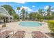A refreshing community pool with surrounding lounge chairs and umbrellas for relaxing by the water at 2306 Lake Woodberry Cir, Brandon, FL 33511