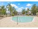 Community swimming pool surrounded by lounge chairs and lush landscaping, perfect for relaxation at 2306 Lake Woodberry Cir, Brandon, FL 33511