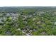 Scenic aerial view of a lush, tree-lined neighborhood with a community pool and well-maintained landscaping at 2373 Hounds Trl, Palm Harbor, FL 34683