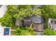 Aerial view of homes and parking areas surrounded by mature trees and landscaping at 2373 Hounds Trl, Palm Harbor, FL 34683