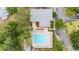 Aerial view of the community pool and parking, surrounded by mature trees and landscaping at 2373 Hounds Trl, Palm Harbor, FL 34683