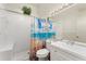 Bright bathroom featuring a tiled walk-in shower with a beach-themed curtain and a white vanity at 2373 Hounds Trl, Palm Harbor, FL 34683